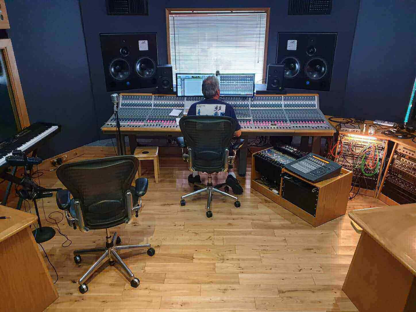 Sound engineer sitting at his 60 channel mixing console