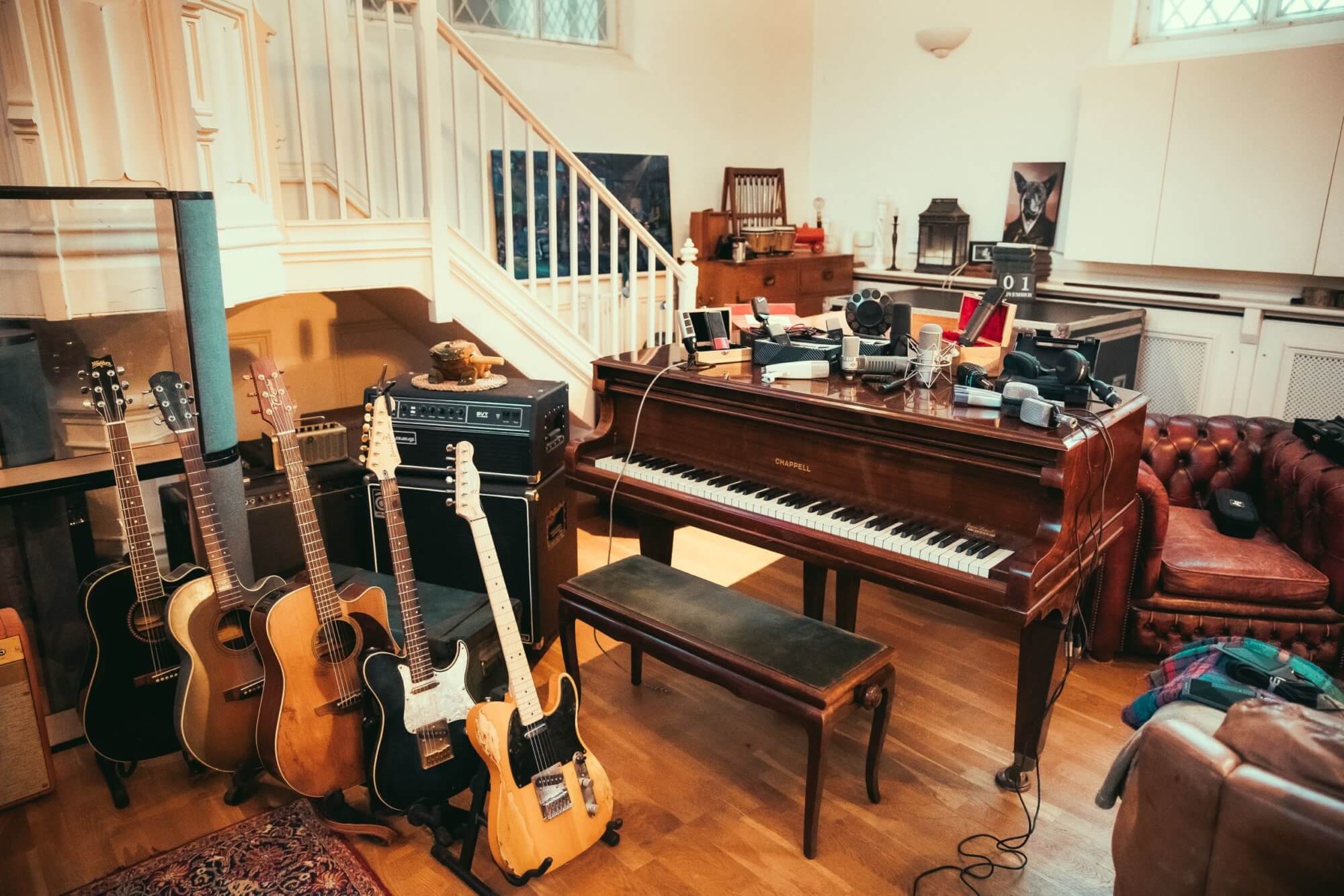 live room in a quirky studio featuring grand piano and loads of instruments