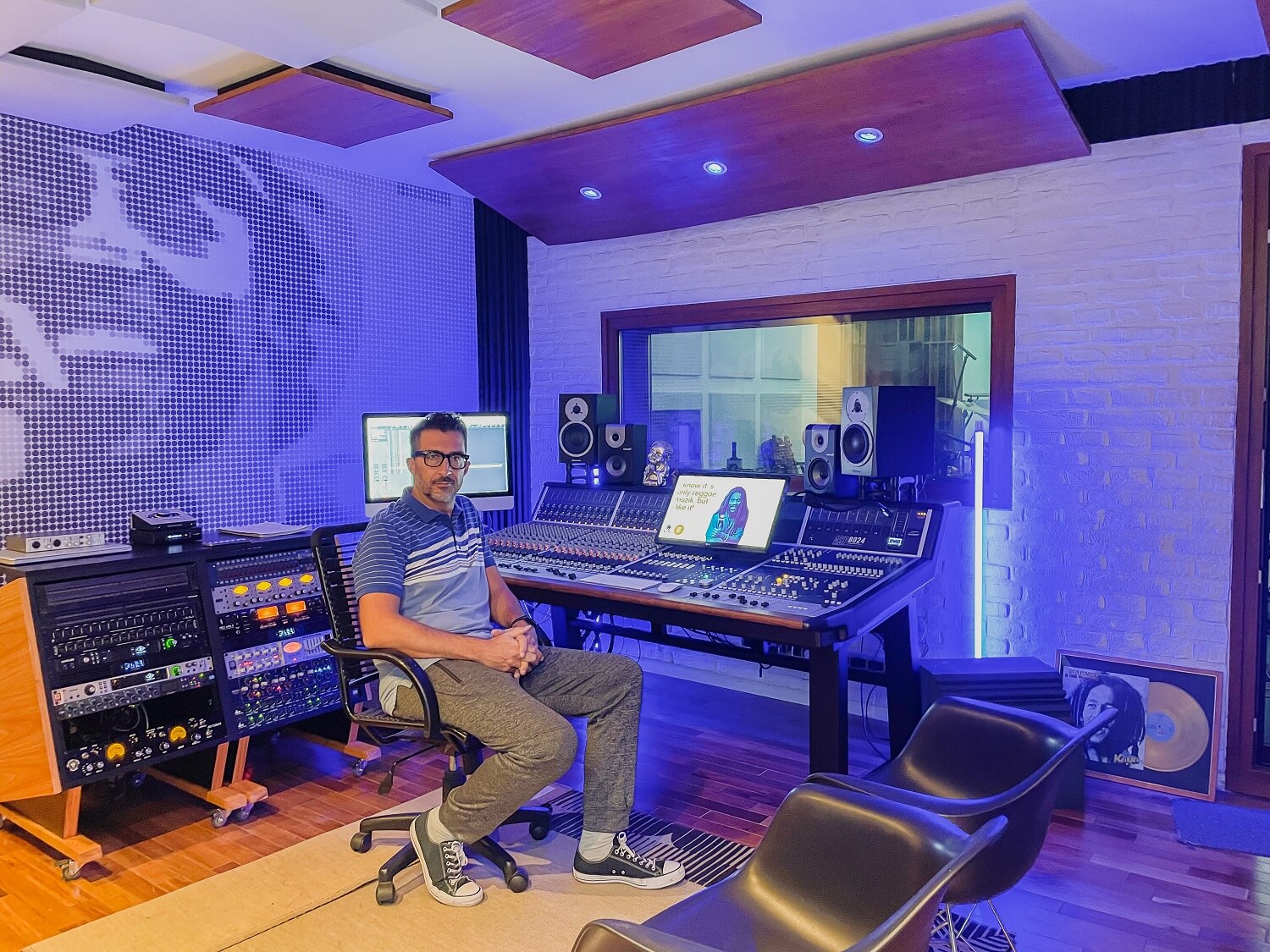 Man sitting at gorgeous mixing console in a studio