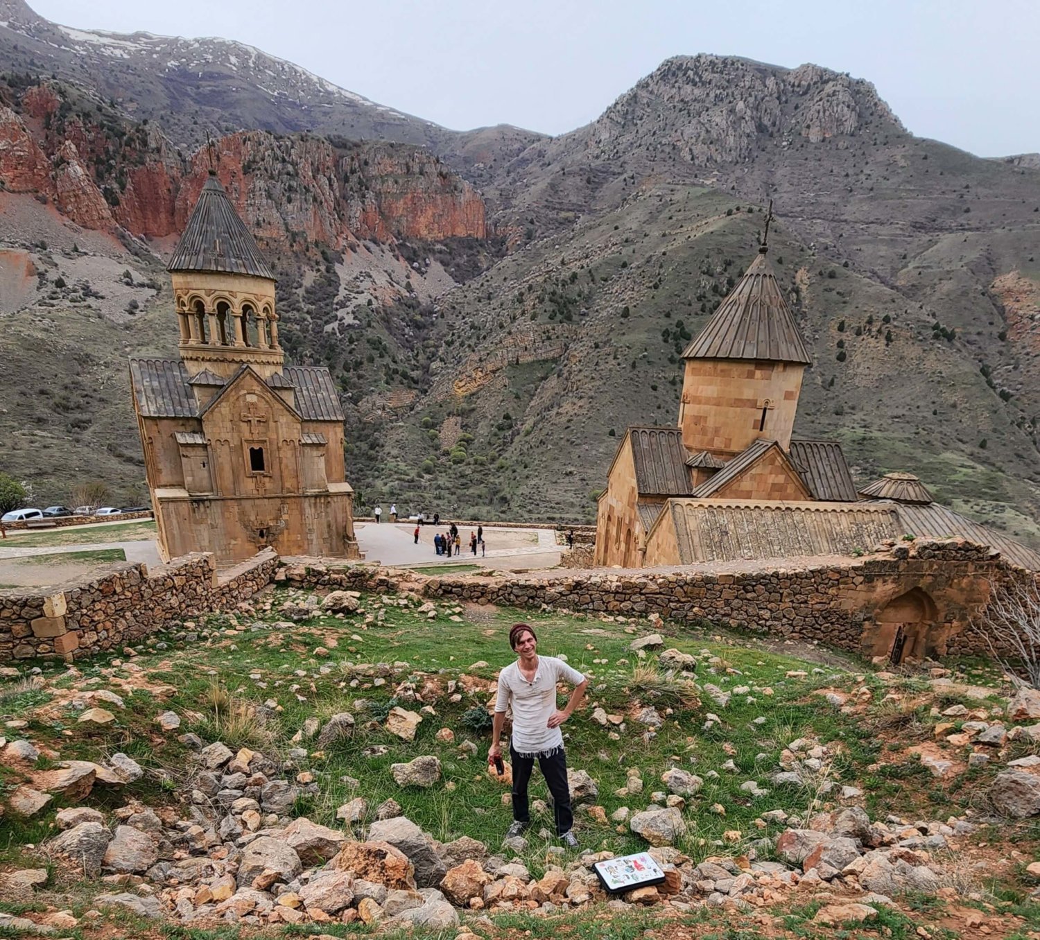 Ancient clerical buildings in front of a stunning mountainscape, and Ady in the foreground with some recording gear