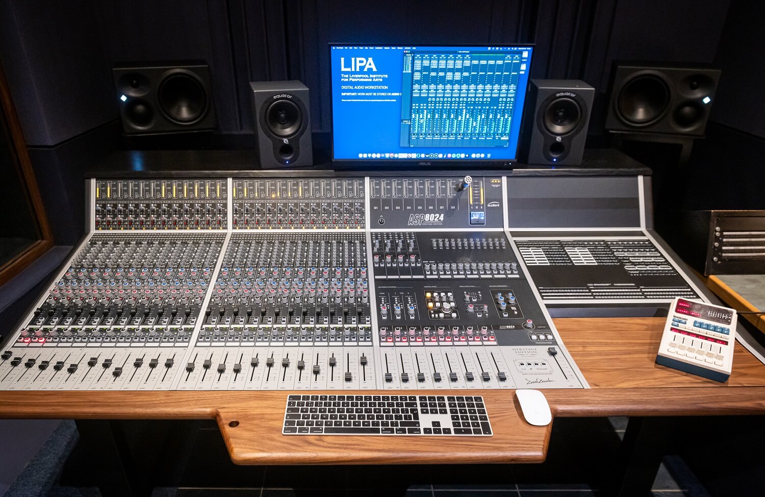 Sleek audio mixing console with keyboard and monitor at LIPA educational facility