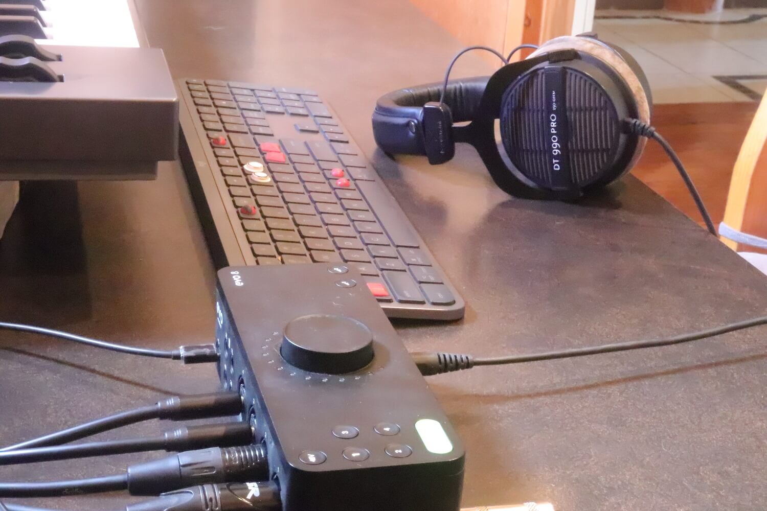 Jenny's workstation desktop featuring headphones, keyboard, midi keyboard and EVO 8 audio interface