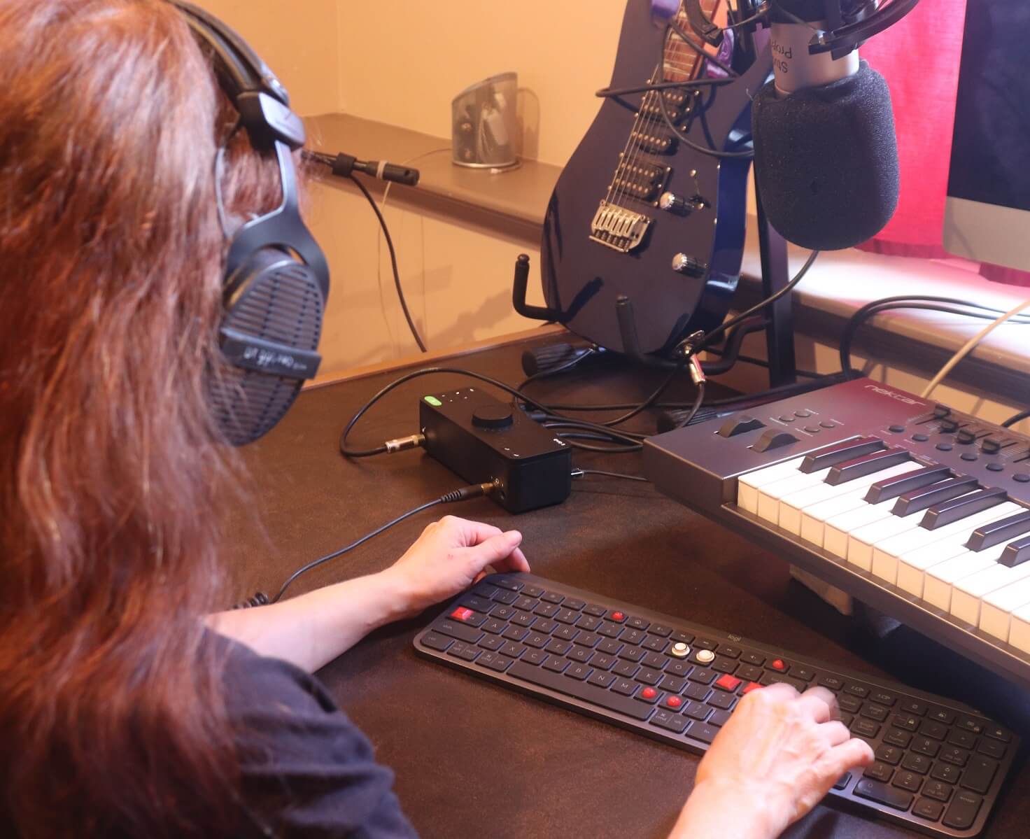 Jenny enjoying accessibility at her audio workstation with EVO 8 audio interface - and her Ibanez which is always plugged in now!