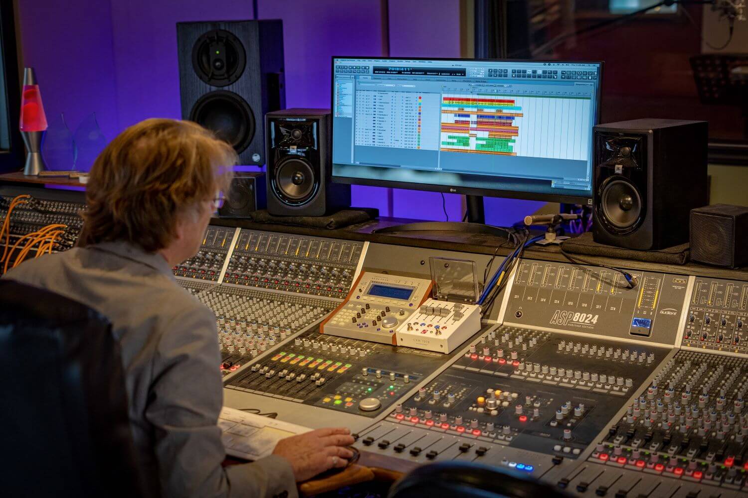 Engineer sits at mixing console at Studio 330