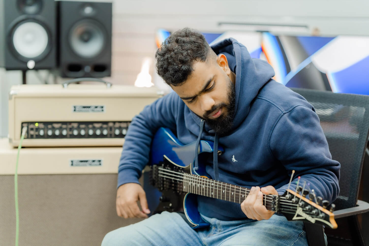 Isiwara plays guitar at his Serene Studio