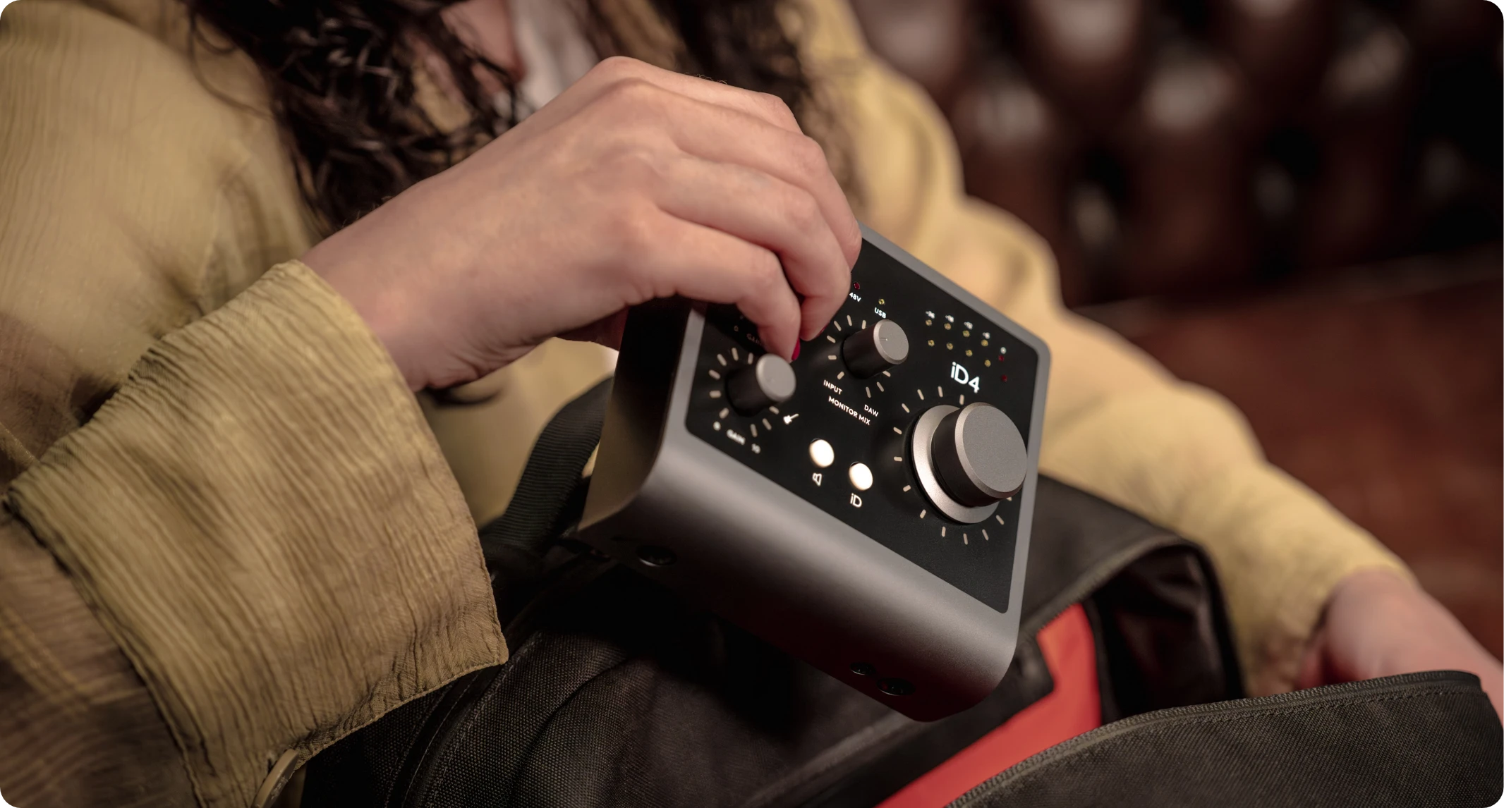 An artist putting the iD4 into their backpack, highlighting portability