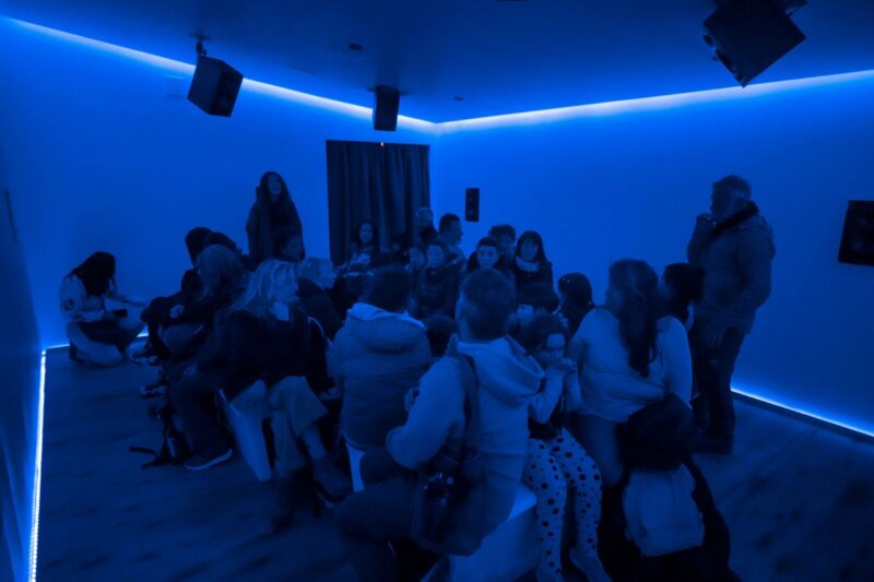 Tourists experiencing the immersive sound experience room at Punta Ballena whale-watching centre