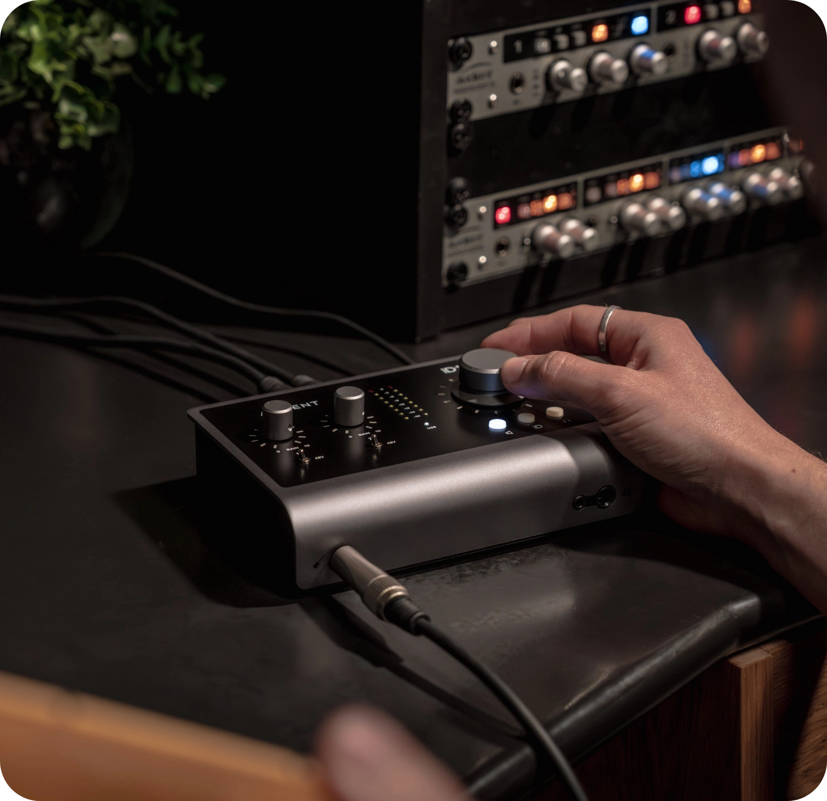 An artist using the iD14 in the studio, adjusting the volume.