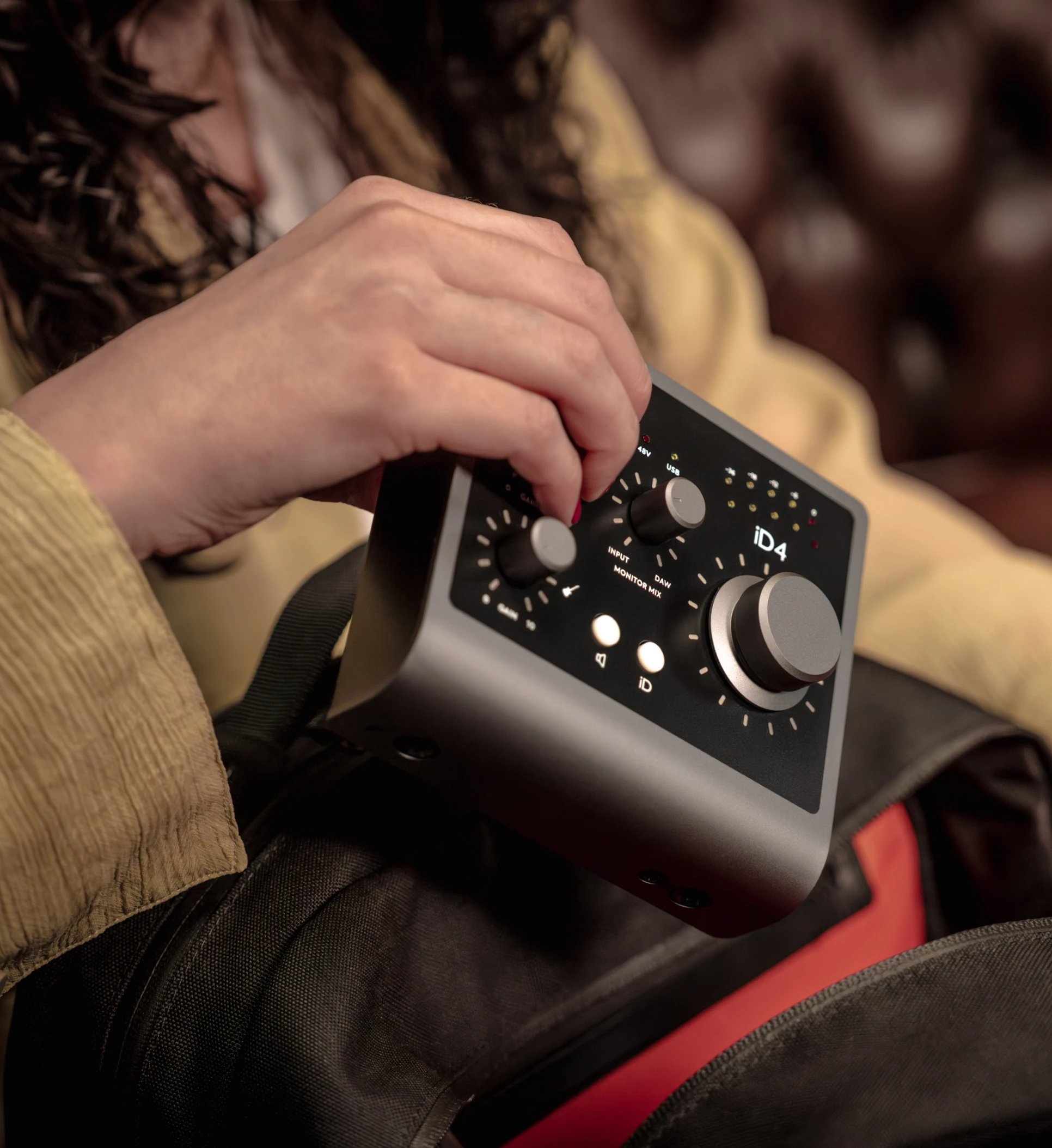 iD4 Audio Interface being placed into a backpack.